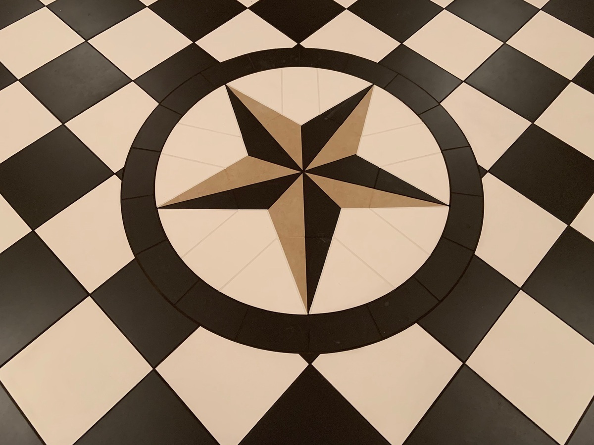 Tile flooring in shape of circle with star in the middle